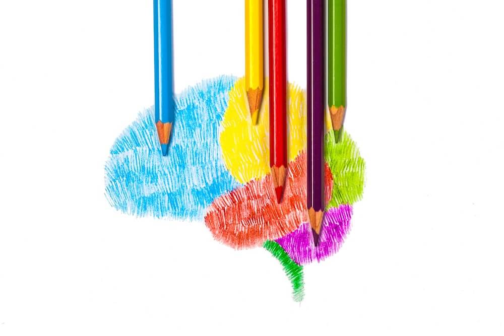 colorful sketch of a brain with colored pencils laying flat.
