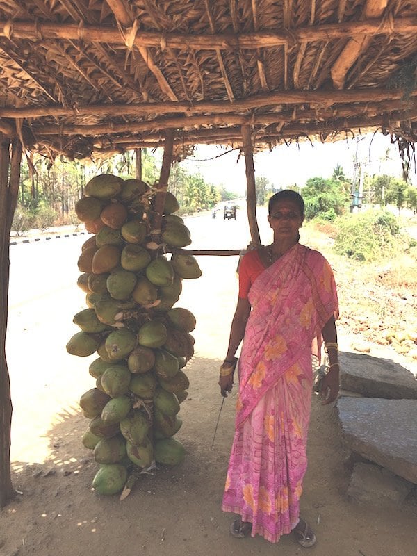 Woman with coconuts in India