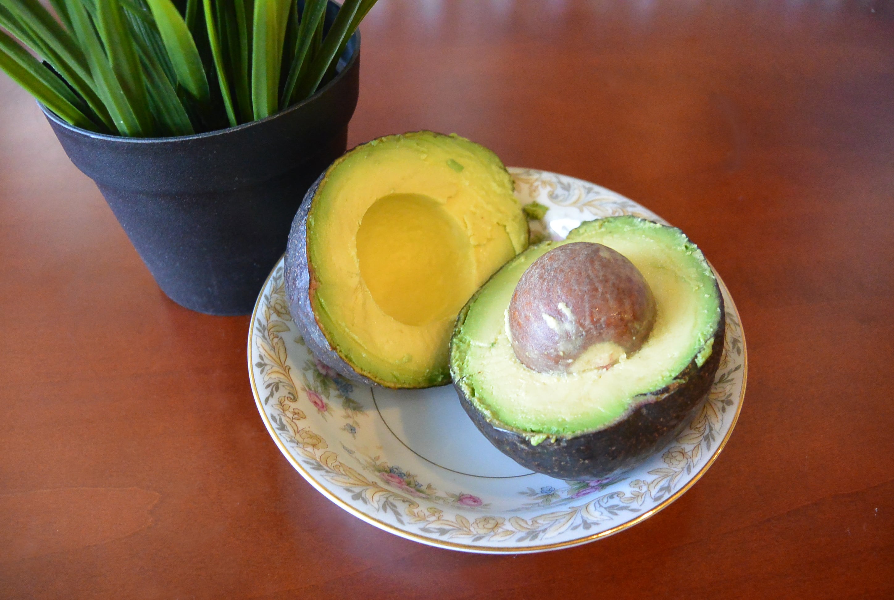 fresh-cut organic avocado on wooden background