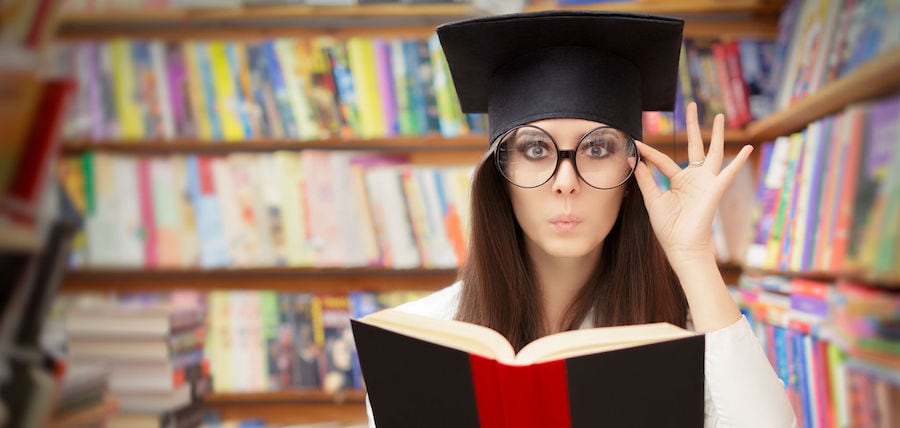 curious school student reading a book in a library