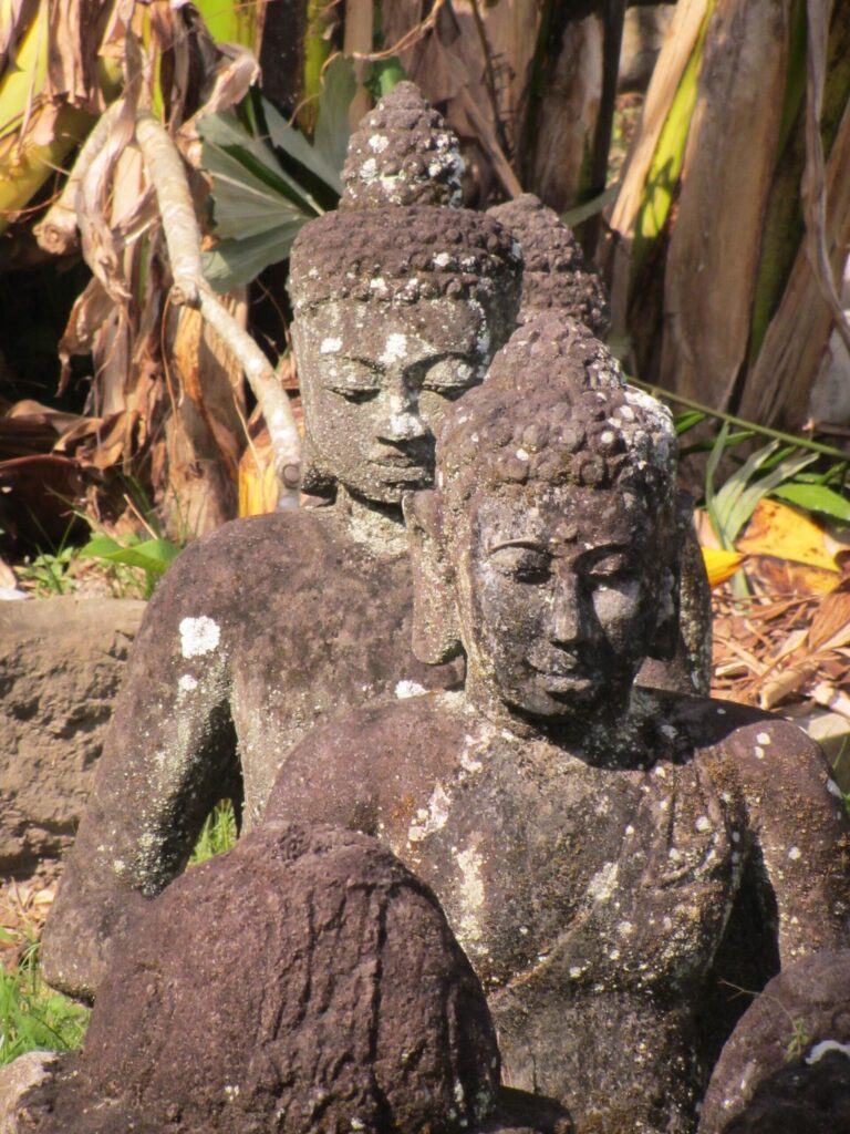 two stone statues of human figures in bali