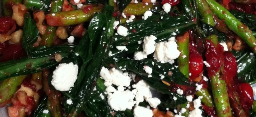 a close up shot of roasted veggies with feta on top of it