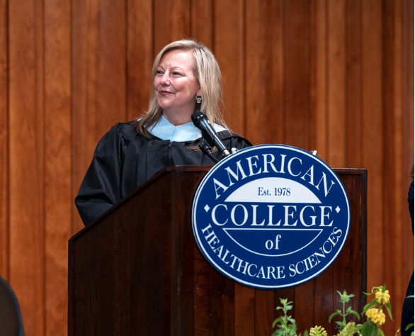 Tracey speaks at a posium at ACHS commencement