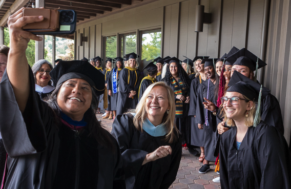 ACHS CAO Tiffany Rodriguez takes a group picture at ACHS commencement