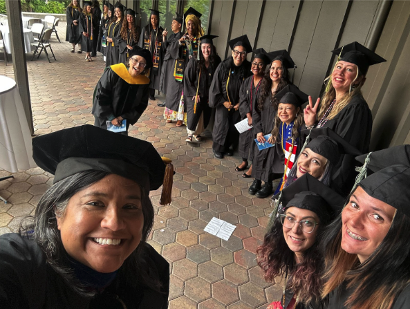 Tiffany Rodriguez poses with graduates at the ACHS commencement ceremony
