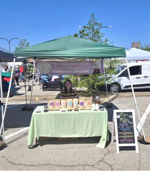 Shannon Carlson at her Vines & Vitality Booth at an outdoor market