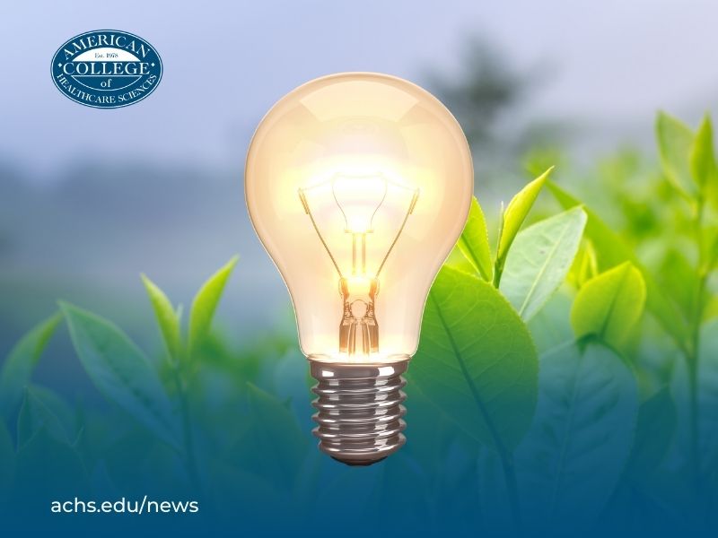 A lightbulb over a background of green leaves