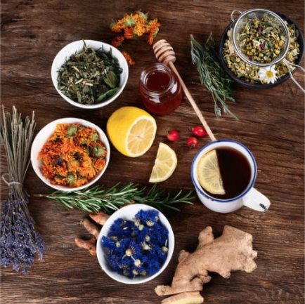 An assortment of dried herbs in bowls on a table