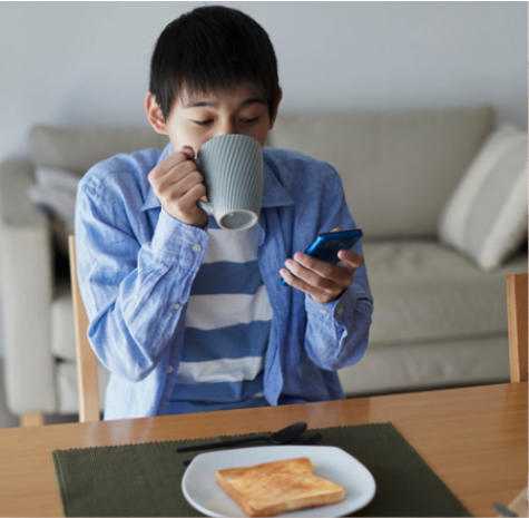 A boy drinking tea at breakfast