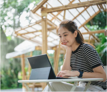 A woman working on a laptop outdoors