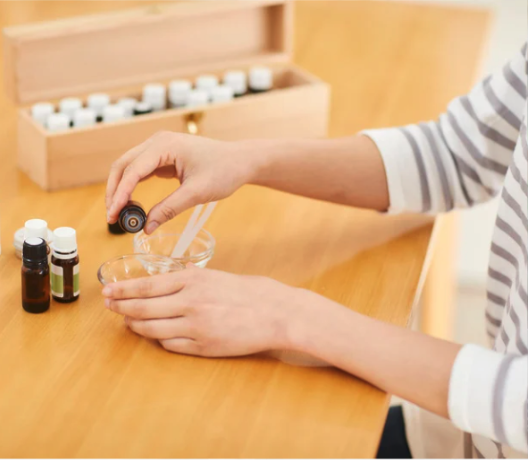 pouring essential oils into a bowl