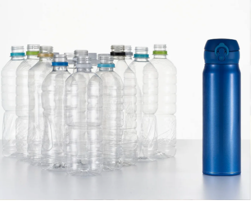 A reusable water bottle next to several single-use plastic water bottles