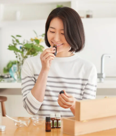 A woman smelling essential oil from a body