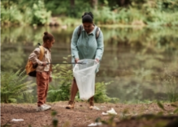 A woman an child picking up litter