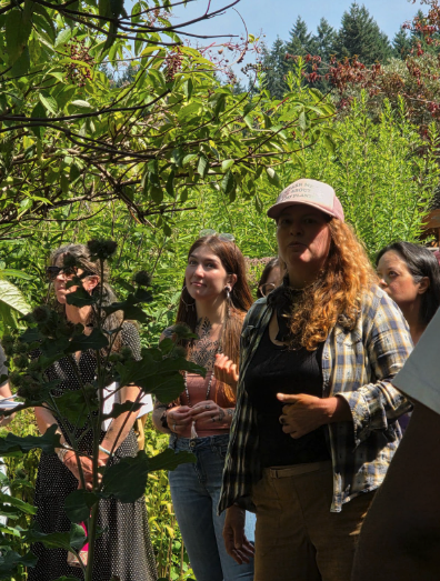 A group taking part in the plant walk in the Bastyr teaching garden.