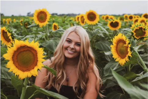 Gabby Stout surrounded by sunflowers