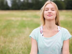a woman outside breathing deeply
