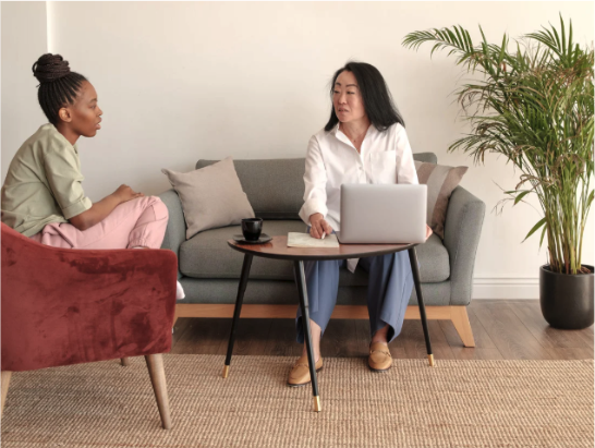 A woman speaking to a wellness coach