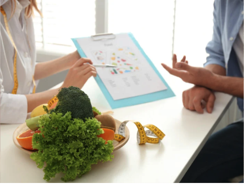 A nutritionist showing a chart to a client