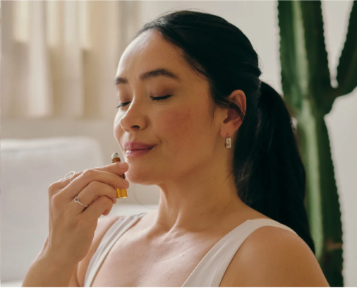 A woman smelling an essential oil