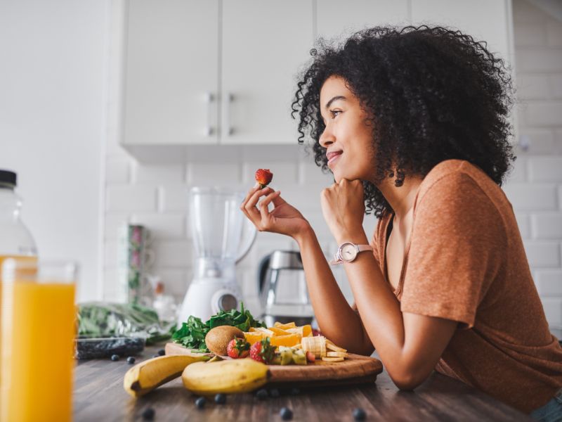 A woman sitting at a counter eating a healthy meal