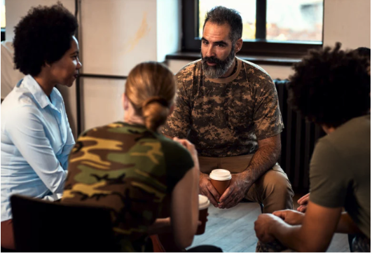 A counselor talking to military vets