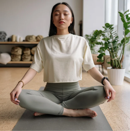 A woman sitting cross-legged meditating
