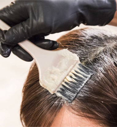Applying hair dye to roots