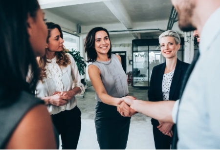 a group of people meeting and shaking hands