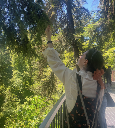 An ACHS graduate looking at foliage on the 2026 Botanical Walk