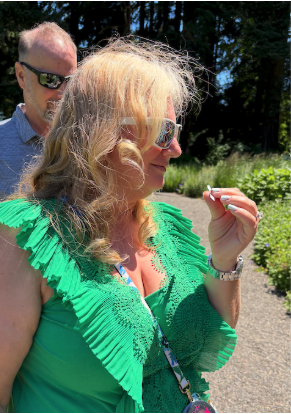 An ACHS Graduate smells a yarrow essential oil sample