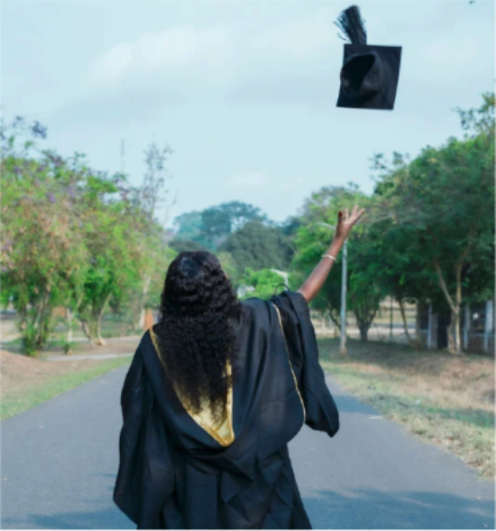 A graduate throwing their cap in the air