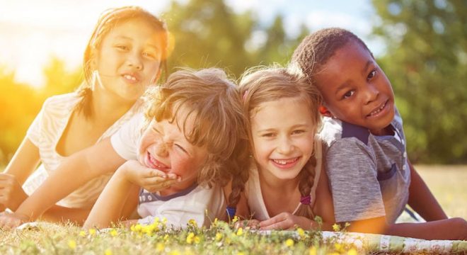 48658671 - interracial group of children in summer having fun and smiling