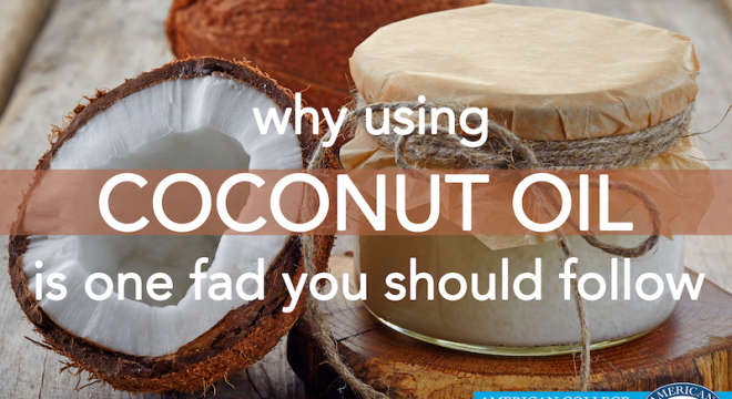 a coconut cracked open leans against a jar of coconut oil on a wooden tabletop. copy overlaid on top of image says "why using coconut oil is one fad you should follow"