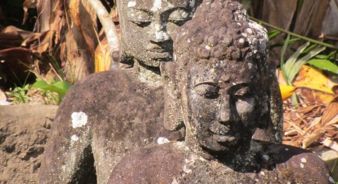 two stone statues of human figures in bali