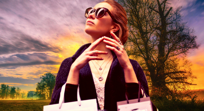 a woman wearing sunglasses and holding two shopping bags on her arms looks up while standing in a field with trees