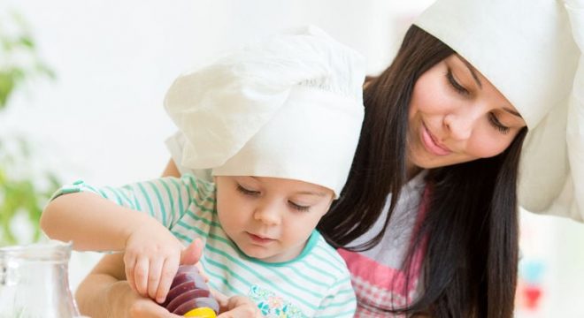 33576415 - mother and little girl making cookies together at kitchen