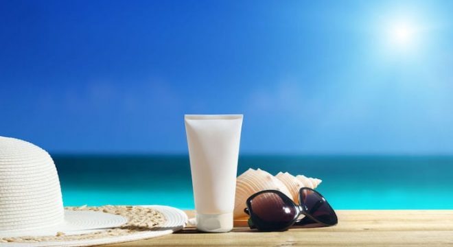33926185 - sun lotion and sunglasses on the beach
