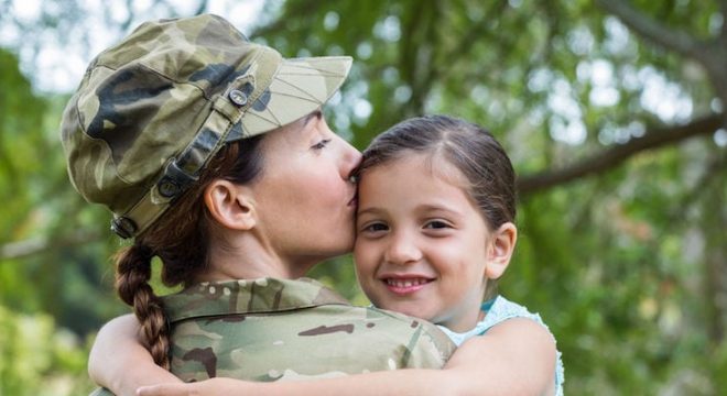 42672398 - soldier reunited with her daughter on a sunny day